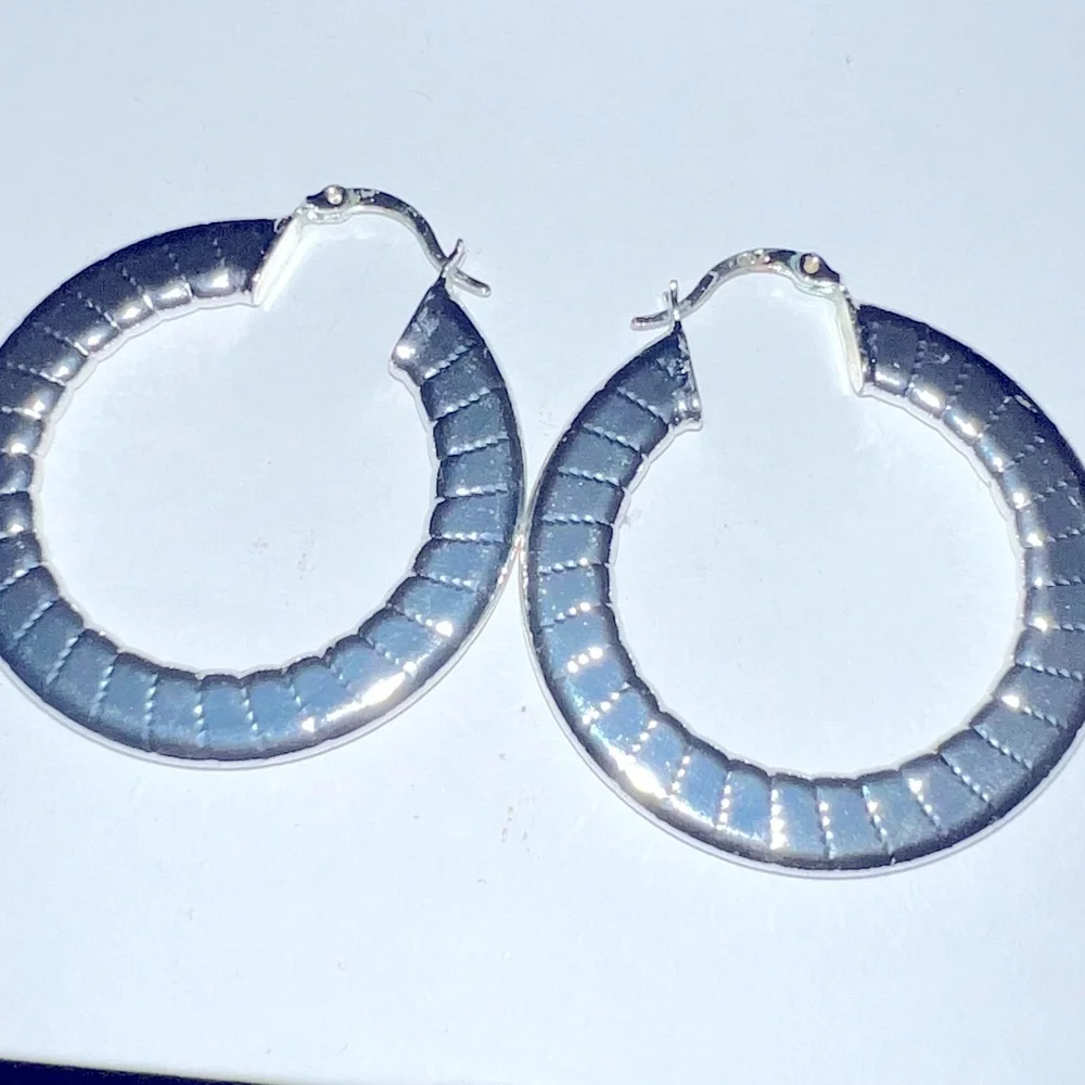 Shiny silver tone hoop earrings 2” length